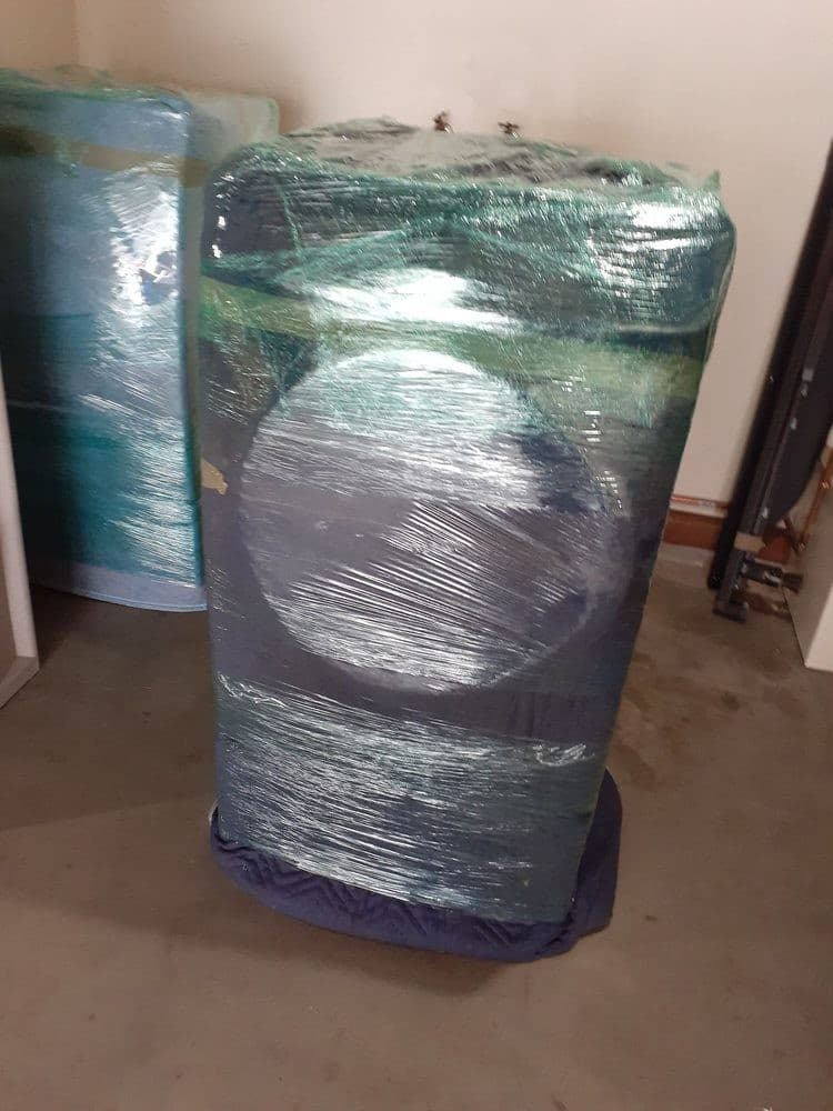 Washer and dryer professionally wrapped and padded for safe moving in Sacramento home.